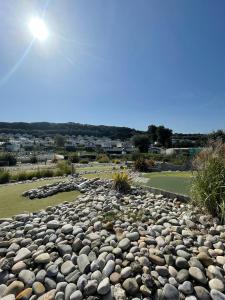 a large pile of rocks on a golf course at 18 Bay View in Wyke Regis