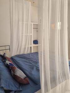 a bed with two pillows on top of it at Villa Nossa in Keur Goonde