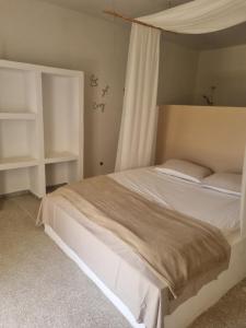 a bedroom with a large bed with white furniture at Villa Nossa in Keur Goonde