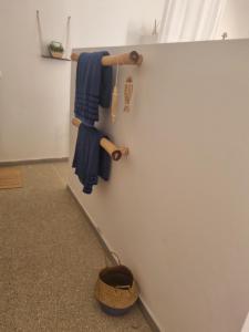 a broom leaning against a wall with a blue towel at Villa Nossa in Keur Goonde