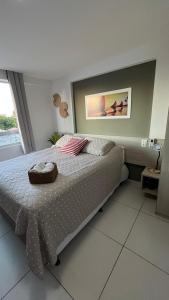 a bedroom with a bed with a picture on the wall at Flat Tambaú - Beira-mar in João Pessoa