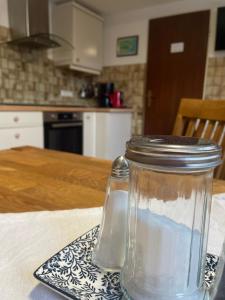 a glass jar sitting on a plate on a table at Glücksmomente in Wolfegg