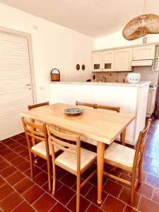 a dining room table and chairs in a kitchen at Villa vista mare a Bosa in Magomadas +61 photos