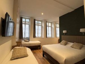 Postel nebo postele na pokoji v ubytování Hotel Le Jacquemart