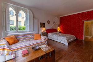 a living room with a couch and a bed at Villa Rossi Residenze d'Epoca in Lucca