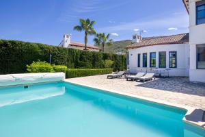 a swimming pool in front of a house at Villa Siegfried JÁVEA in Benitachell