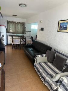 a living room with a black couch and a table at Atlantic 10 in Atlántida