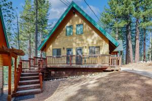 a home with a large deck in the woods at Tallac Views Getaway in South Lake Tahoe