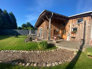 a log cabin with a yard and a patio at Morgensonne in Putbus