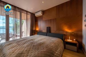 a bedroom with a large bed and a balcony at Вилла Biala family haven in Byala +36 photos