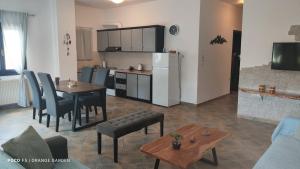 a living room with a kitchen and a dining room at Orange Garden in Kala Nera