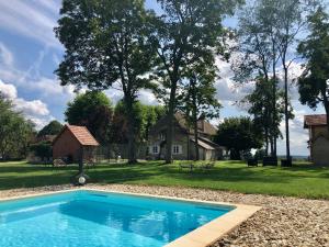 a blue swimming pool in front of a house at L'annexe in Bragny-sur-Saône