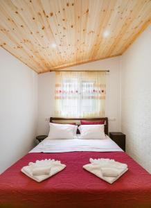 a bedroom with a bed with two towels on it at The Woodnest in Vonitsa