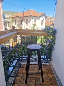a stool sitting on top of a balcony at YaVi's Central Apartment in Veliko Tŭrnovo