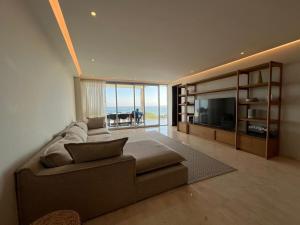 a living room with a couch and a television at Luxury Villa in Punta Mita in Higuera Blanca