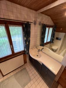 a bathroom with a sink and a tub and a toilet at Chalet Karin in Sankt Niklaus +21 photos