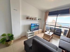 a living room with a couch and a large window at Horizon Santa Monica in Aguadulce