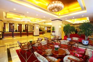 a dining room filled with tables and chairs at Sunworld Hotel Wangfujing in Beijing
