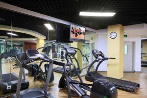 a gym with several cardio machines and a clock at Sunworld Hotel Wangfujing in Beijing