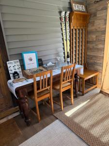 a wooden table with chairs and skis on a wall at Walnut Grove in Ashland