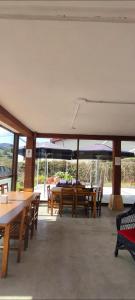 a dining room with tables and chairs and windows at Akarregi-Kanpaia albergue de peregrinos in Getaria