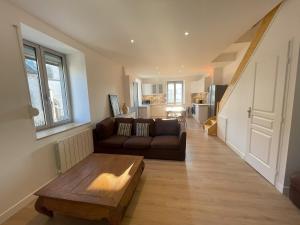 a living room with a couch and a coffee table at Duplex Vittel Centre Ville in Vittel