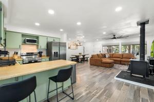 a large kitchen and living room with a stove at Modern Lakeside Family Fun Cabin in Pinetop-Lakeside