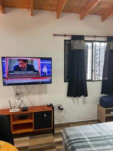 a bedroom with a flat screen tv on the wall at Estudio Relax Las Sierras in El Volcán