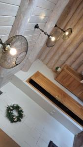 two lights hanging from the ceiling of a room at Brīvdienu lauku māja in Garkalne +30 photos
