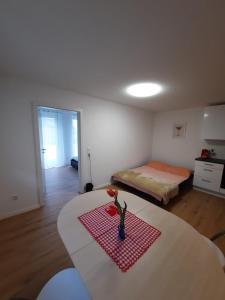 a room with a table and a bed in a room at Ferienwohnung Mergel in Black Forest in Zell im Wiesental