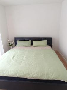 a bed with a black headboard in a bedroom at Ferienwohnung Mergel in Black Forest in Zell im Wiesental +26 photos