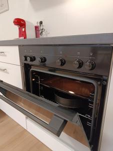 a black oven with a pan inside of it at Ferienwohnung Mergel in Black Forest in Zell im Wiesental +25 photos