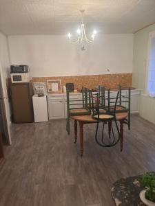 a kitchen with a table and chairs in a room at appartement de letty in Fort-Mahon-Plage