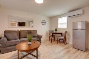 a living room with a couch and a table at 3 Mi to Main St and Beach Coastal Cape Cod Escape! in Wareham