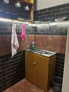 a kitchen with a sink and a towel on a wall at Sweet Dream Overnight 2 in Postmasburg +3 photos