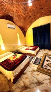 two beds in a room with a brick wall at شمس تونس in Tunis +17 photos