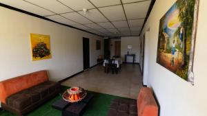 a hallway with couches and a table in a room at Xios Apartment in Guayaquil