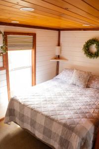 a bedroom with a large bed in a room at Charming Cabin with Pond View and Private Hot tub in Carthage