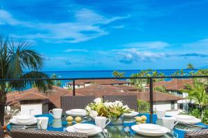 a dining table with a view of the ocean at Luxury & Views At Aqua Lani J305 Wailea Beach Villas! in Wailea