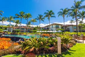 a resort with a swimming pool and palm trees at Luxury & Views At Aqua Lani J305 Wailea Beach Villas! in Wailea