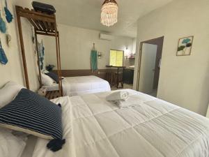 Postel nebo postele na pokoji v ubytování BACALAR INN Hotel