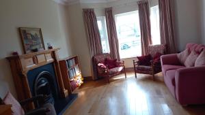 a living room with a couch and a fireplace at Dungloe House in Dungloe