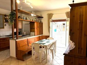 a kitchen with a table and chairs in a kitchen at Nelly's house in Terrasini