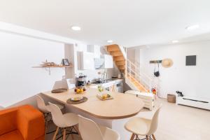 a kitchen and dining room with a table and chairs at Nikkon summer home in Matala