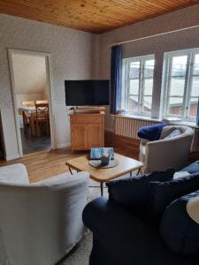 a living room with two couches and a table at Ferienhof Bisdorf "Steilküste" in Bisdorf