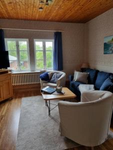 a living room with two couches and a coffee table at Ferienhof Bisdorf "Steilküste" in Bisdorf +11 photos