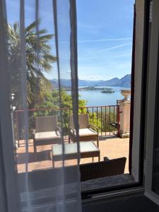 a view of a balcony with a view of the water at La Mulattiera - vista lago in Baveno