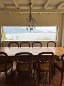 a dining room table with chairs and a chandelier at La Mulattiera - vista lago in Baveno