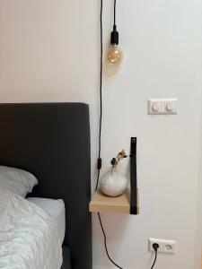 a bedroom with a bed and a table with a lamp at Studio Schipper in Alkmaar