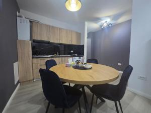 a kitchen and dining room with a table and chairs at Studio Magheru Residence in Craiova +8 photos